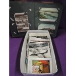 An album and box of vintage postcards