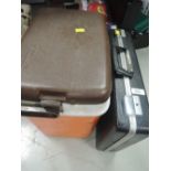 A vintage orange cooler box and briefcase