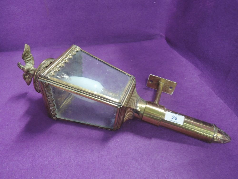 A brass carriage style outside lamp with eagle fineal