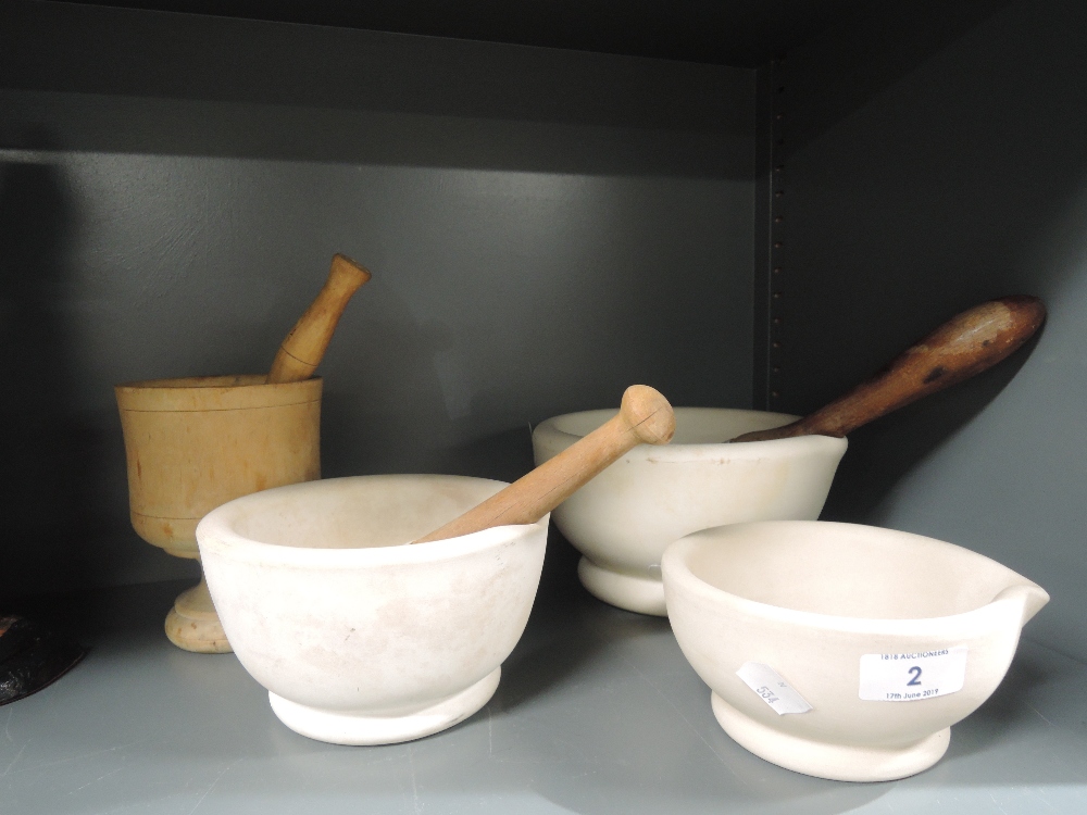A selection of kitchen or medicine mortar and pestle both ceramic and wooden designs