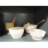 A selection of kitchen or medicine mortar and pestle both ceramic and wooden designs