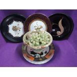 A selection of plates and stone carved fruit and bowl