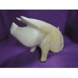 A very heavy hand carved soap stone or similar pig or piglet figure