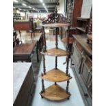 A Victorian walnut corner whatnot/etage having inlay decoration and spindle frame