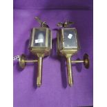 A pair of outside brass topped lamps