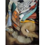 A mixture of vintage items including scarves, hats and a fur tippet.