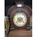 A late Victorian/Edwardian stained frame mantel clock of architectural form having circular Roman