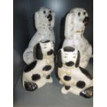 A selection of mirrored ceramic dog figures including white glaze with glass eyes