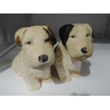 A pair of plaster cast dog figures