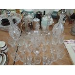 A selection of fine cut and etched glass wares including decanter pair and wine glasses