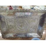 An Indian white metal tray bearing elephant, turkey and scroll decoration