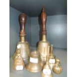 A selection of brass cast bells including two town crier style