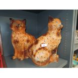 A pair of mirrored ceramic tabby cat figures in ginger