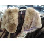 A vintage fox fur cape having feet and another fur stole,some wear.