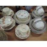 A selection of tea cups and saucers including hand decorated