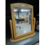 A wooden framed bathroom mirror