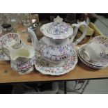 An early 19th century part tea service in the Rockingham style having lustre floral decoration