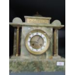 A late 19th/early 20lth century onyx mantel clock of architectural form, having circular Roman