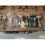 A selection of brass cutlery and flatware with bamboo design handles