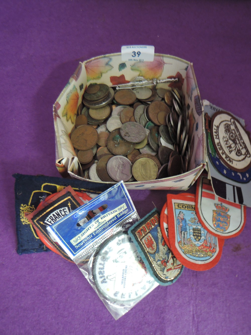 A selection of collectable currency and sew on travel patches