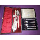 A small selection of plated flatware including cased fish servers, cake forks, teaspoon with crossed