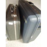 Two hard bodied travel trunk suitcases