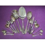 A small selection of silver plated flatware including a Norwegian cake slice, sugar nips, berry