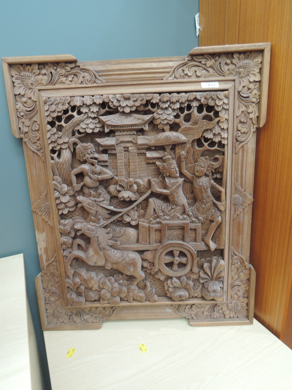 An Oriental carved panel, mythical creatures, including Hanuman