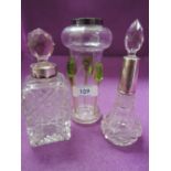 A cut glass perfume bottle having HM silver collar, marks worn, another similar pressed glass bottle