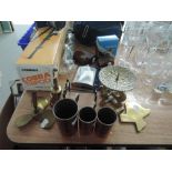 A selection of brass and copper wares including graduated measures and barrel screw