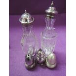 A selection of pepperettes including two tall glass with HM silver lids, single HM silver pepperette