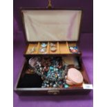 A modern jewellery box containing a selection of costume jewellery including brooches, earrings,