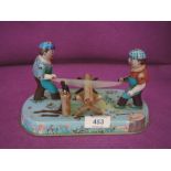 A tin plate toy of two lumber jacks