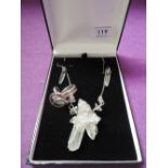 A three piece set of white metal and quartz jewellery including large pendant, drop earrings and