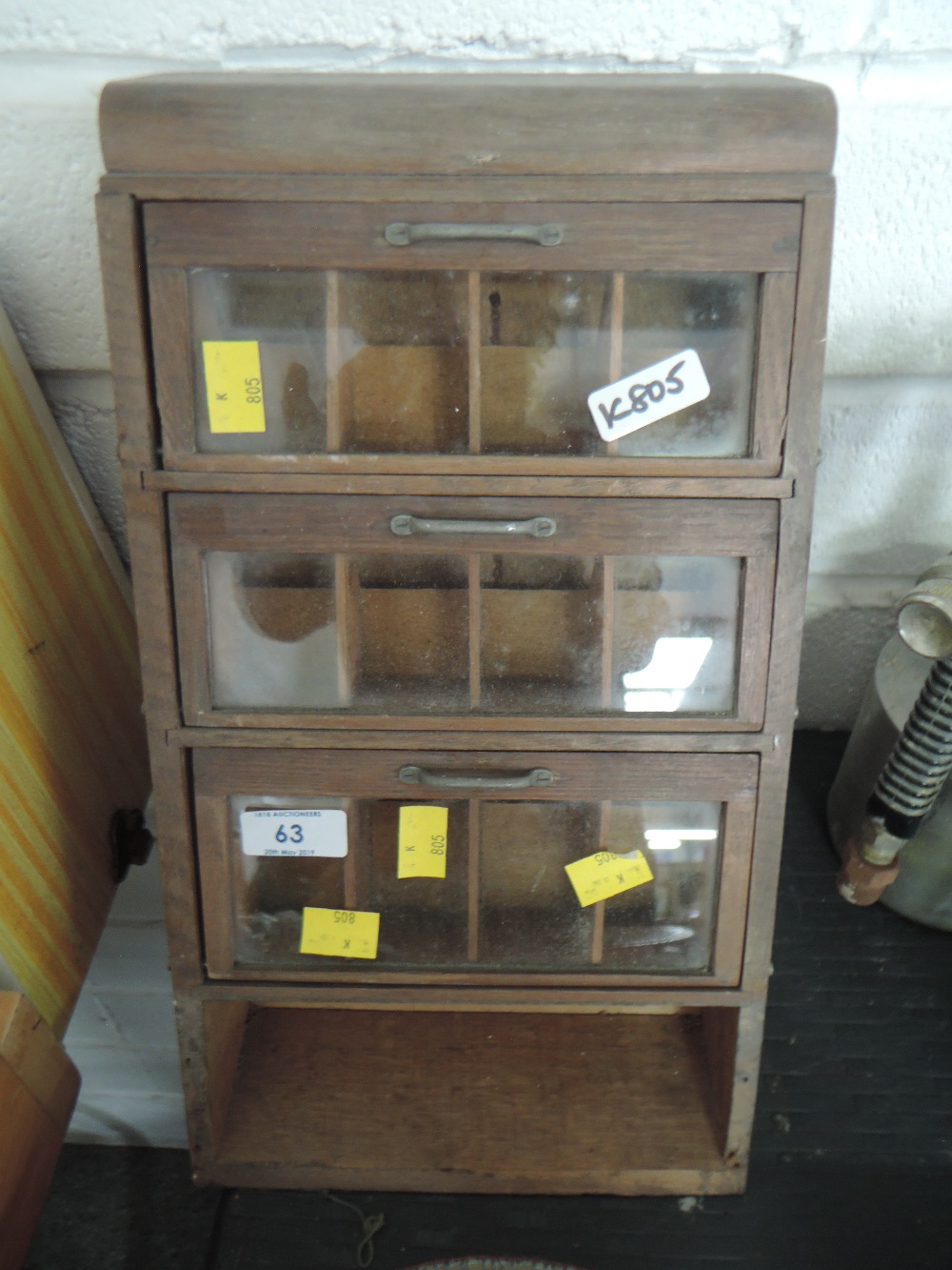 A small shop counter or kitchen spice haberdashery or similar cabinet