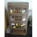 A small shop counter or kitchen spice haberdashery or similar cabinet