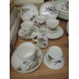 A selection of tea cups and saucers delicately hand painted with various birds marked M & D to base