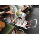 A Triang painted wood and composition rocking horse on metal frame and a vintage pram