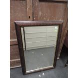 A modern mahogany effect wall mirror