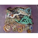 A selection of costume jewellery including strings of beads, simulated pearls, crystal beads,