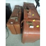 Two vintage leather bound suitcases or travel trunks