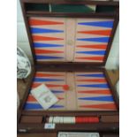 A wood cased backgammon and games set or compendium dated 1977