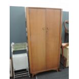 A vintage golden oak wardrobe, labelled Austinsuite