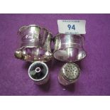 Two HM silver napkin rings and a pair of glass pepperettes with white metal lids stamped sterling