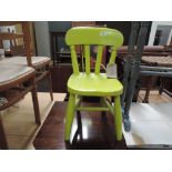 A traditional childrens chair, lime green paint finish