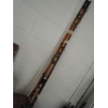 A selection of early cane and wooden fishing rods in various designs and styles