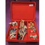 A beaded jewellery box containing a selection of costume jewellery brooches etc