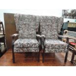 A pair of vintage wing back armchairs