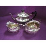 A silver plated matched three piece tea set having Hard wood handle and finial with bun feet to