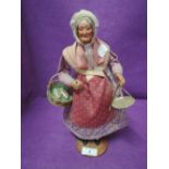 An antique figure of a fish peddler or street seller woman, French Santos standing 12inch tall